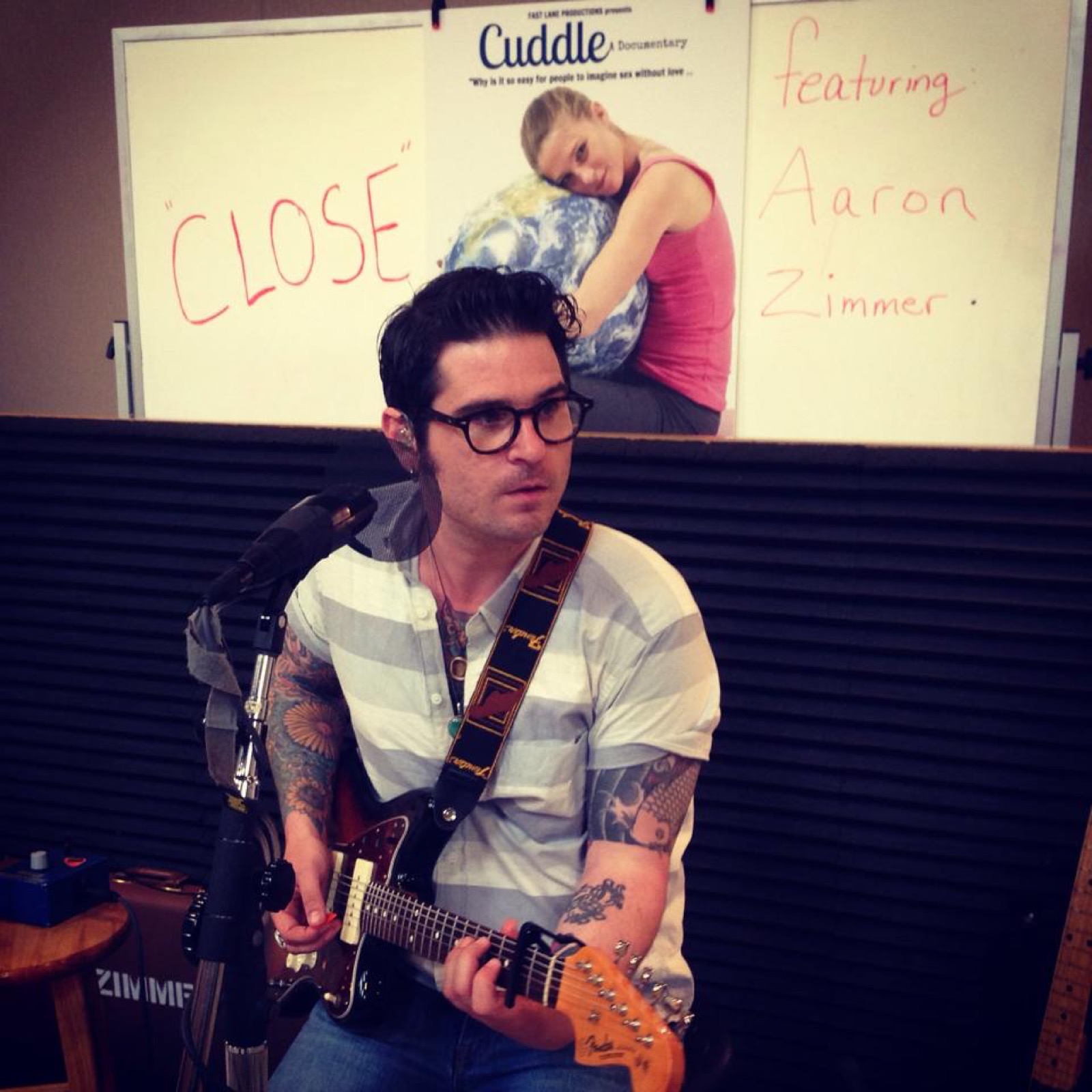 A guitarist performing during a recording session