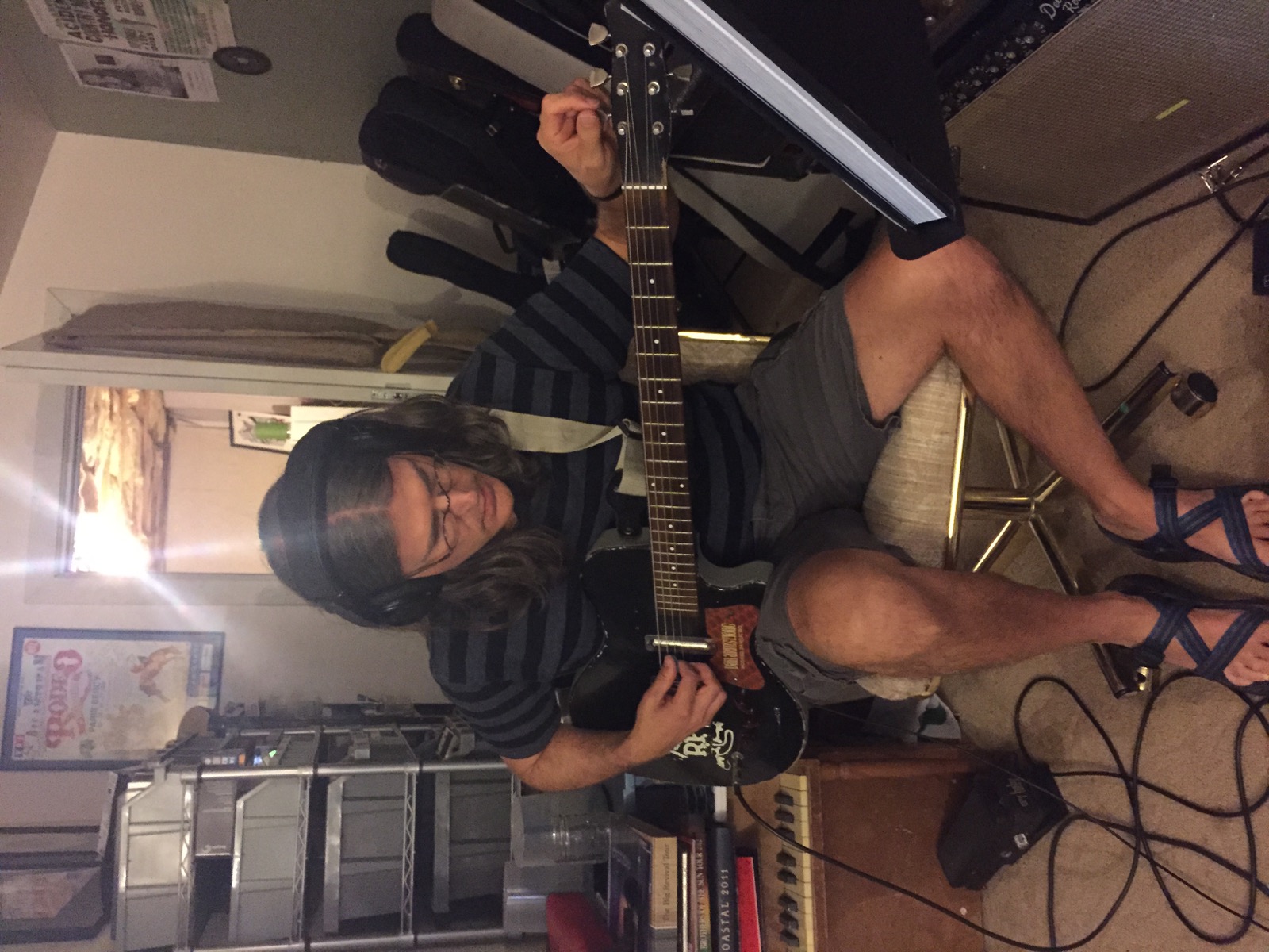 A guitarist tracking during a studio session